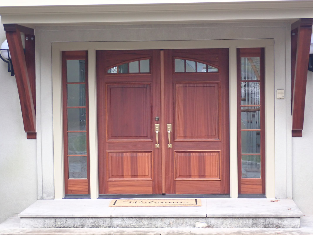 Pre hung mahogany entry door with sidelites matching mahogany braces hold up new overhang